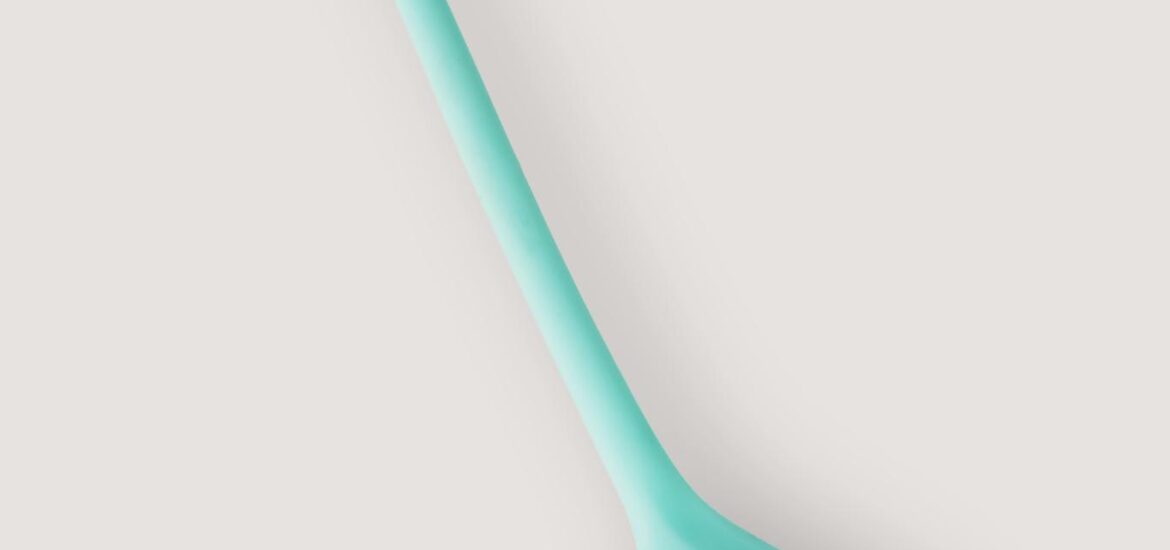 Photo by IFONNX Toys Close-up of a teal vibrator showcasing its sleek and modern design, ideal for personal wellness.