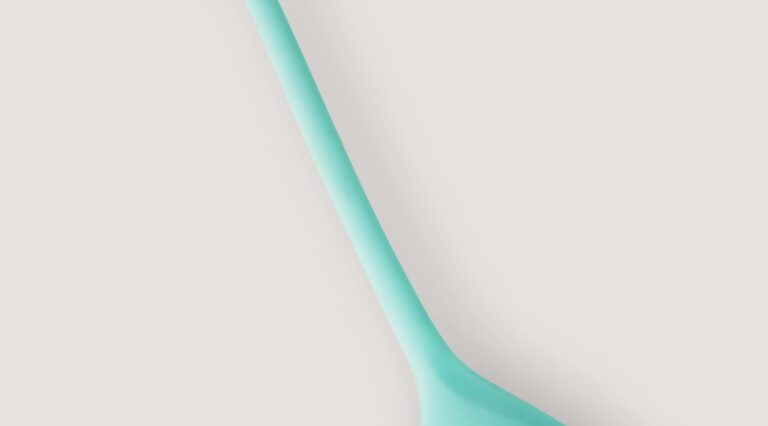 Photo by IFONNX Toys Close-up of a teal vibrator showcasing its sleek and modern design, ideal for personal wellness.