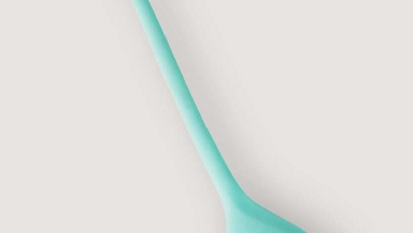 Close-up of a teal vibrator showcasing its sleek and modern design, ideal for personal wellness.
